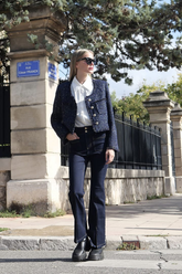 a lady in a white shirt, a grey sequin tweed jacket and a pair of black jeans